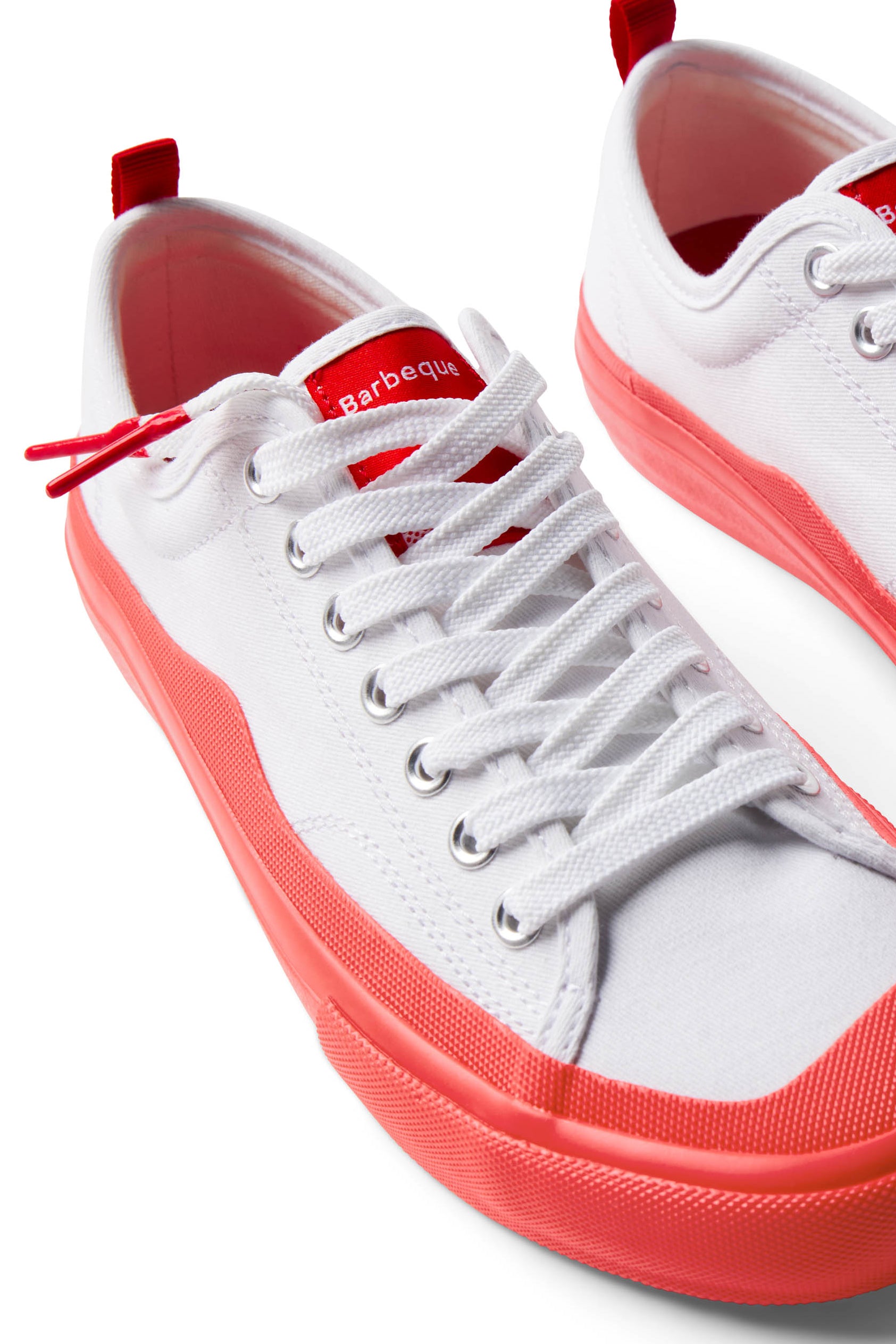 Pair of Dipped Kicks white shoes with red soles