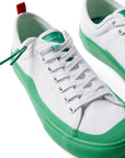 Pair of Dipped Kicks white shoes with green soles