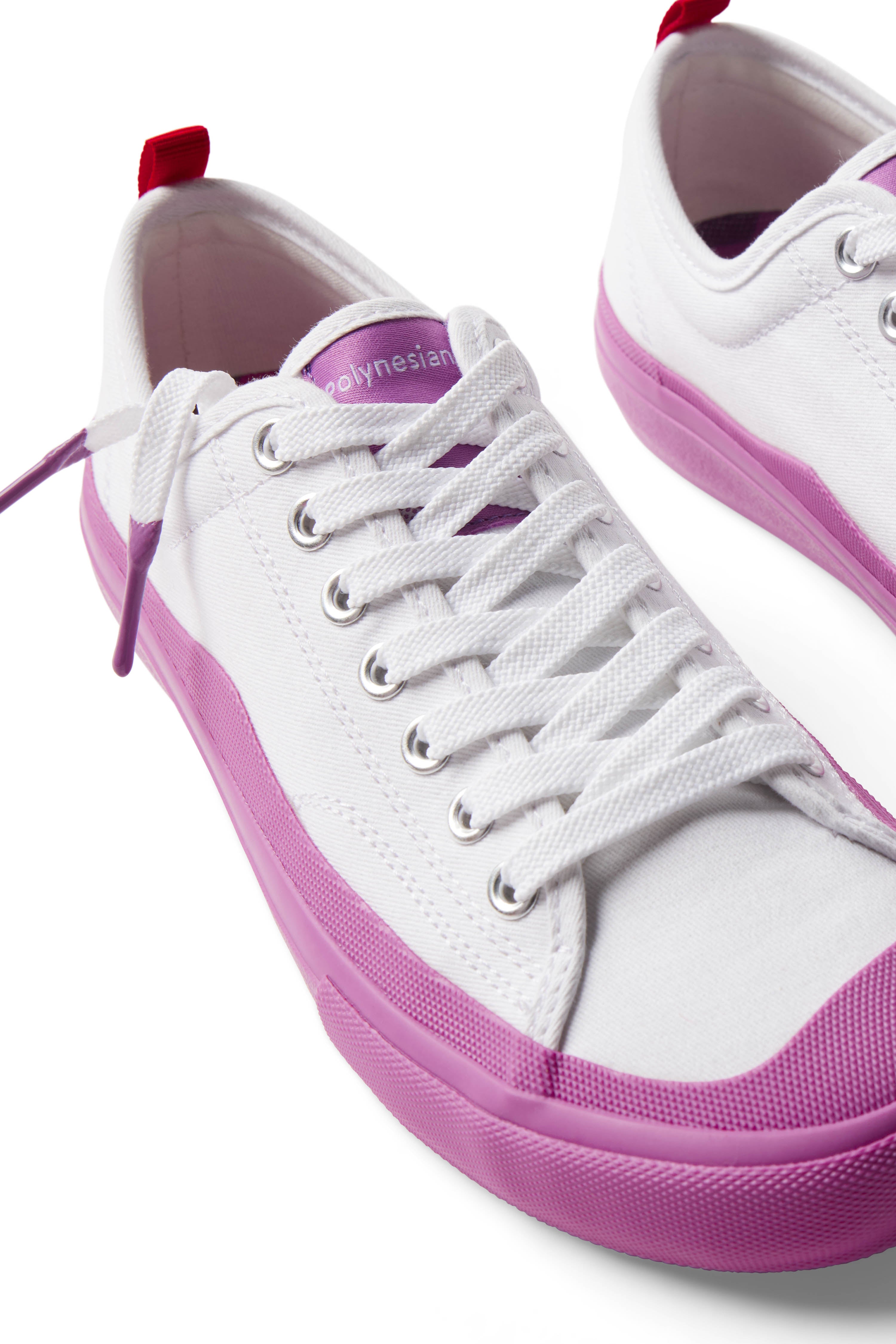 Pair of Dipped Kicks white shoes with purple soles