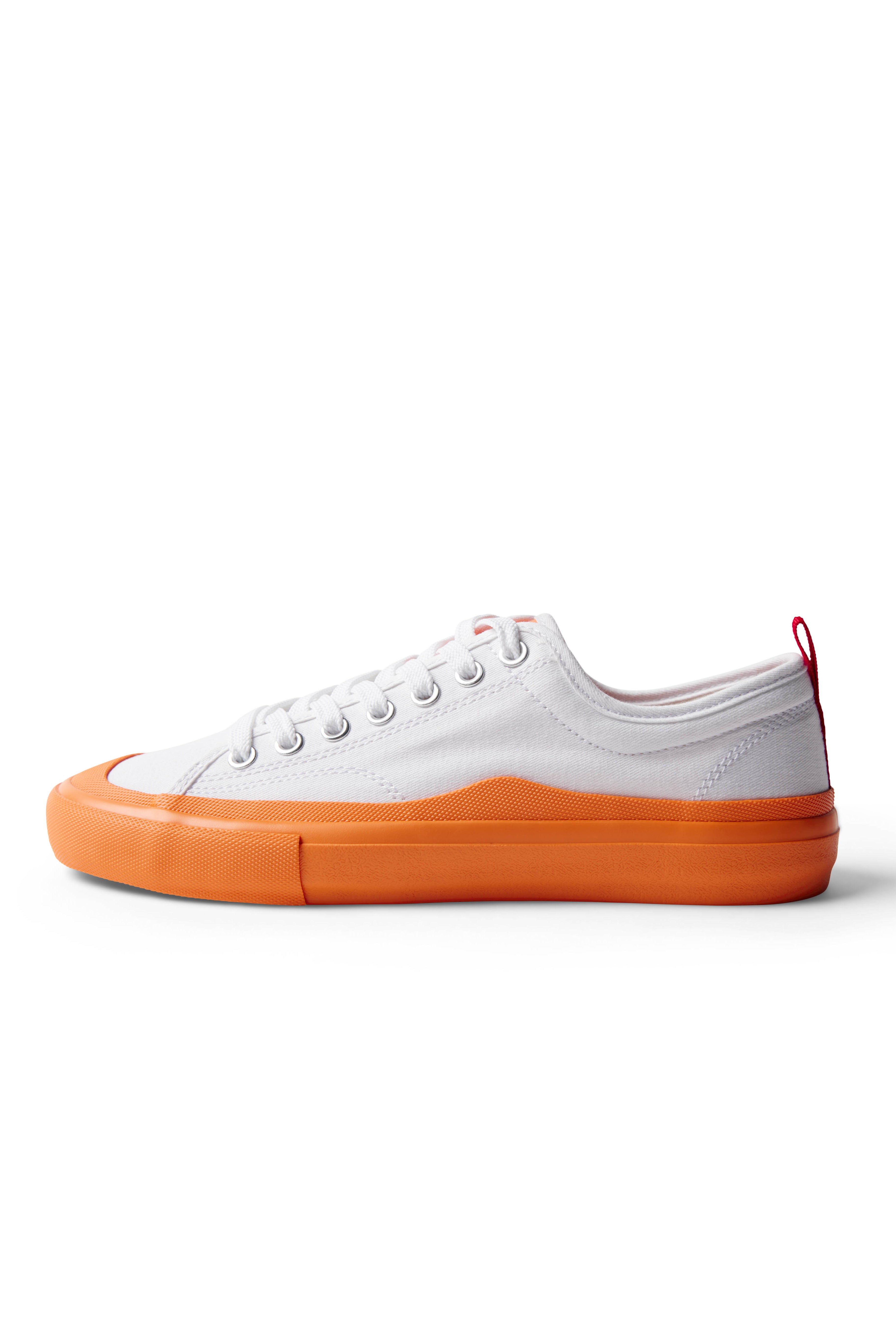 Side view of single Dipped Kicks white shoes with orange soles