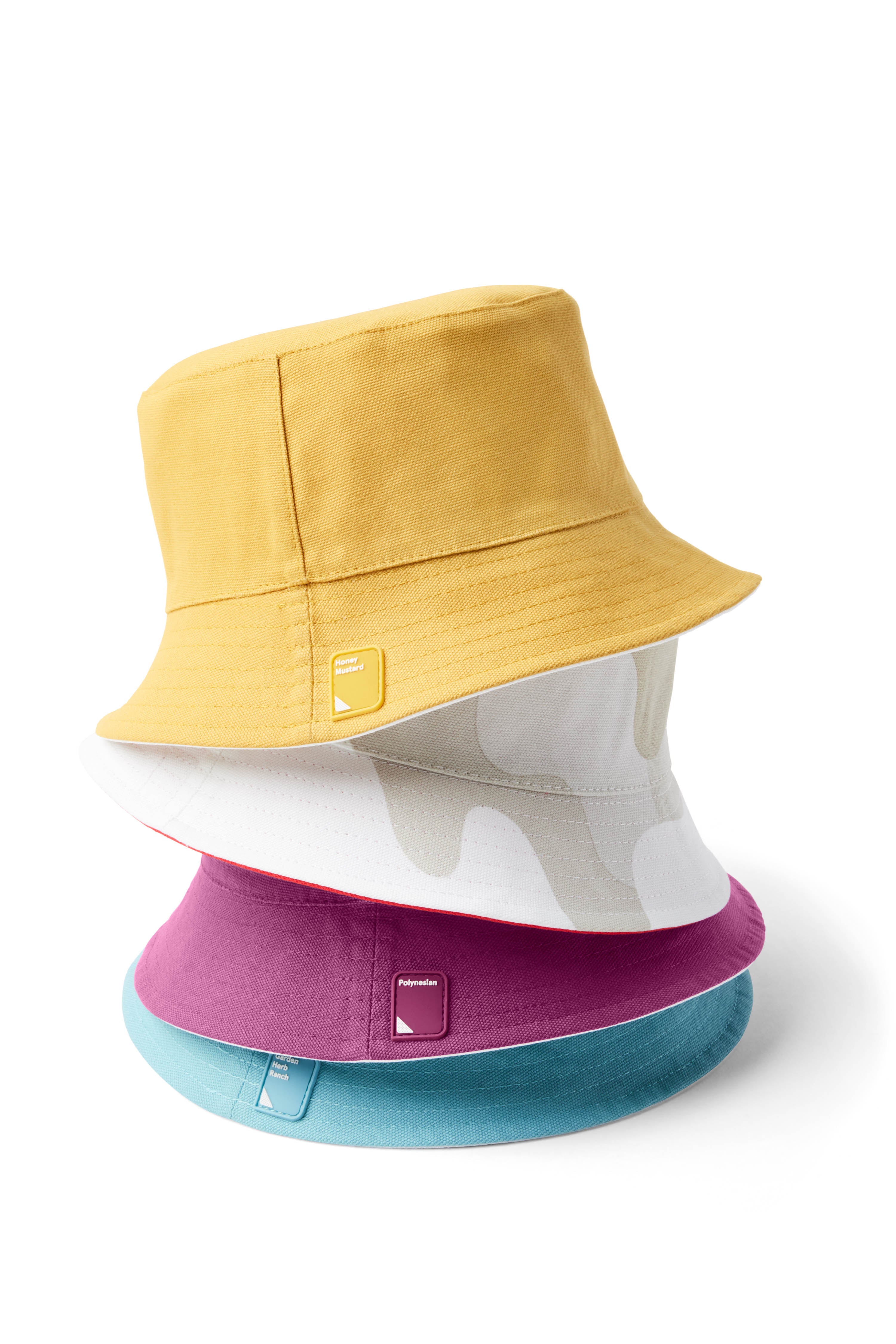 Yellow, gray/white, purple, and blue stack of Reversible Bucket Hats