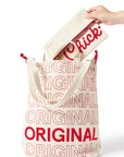 Person placing Classic Chick-fil-A™ Clutch into Chick-fil-A Original Bucket Tote