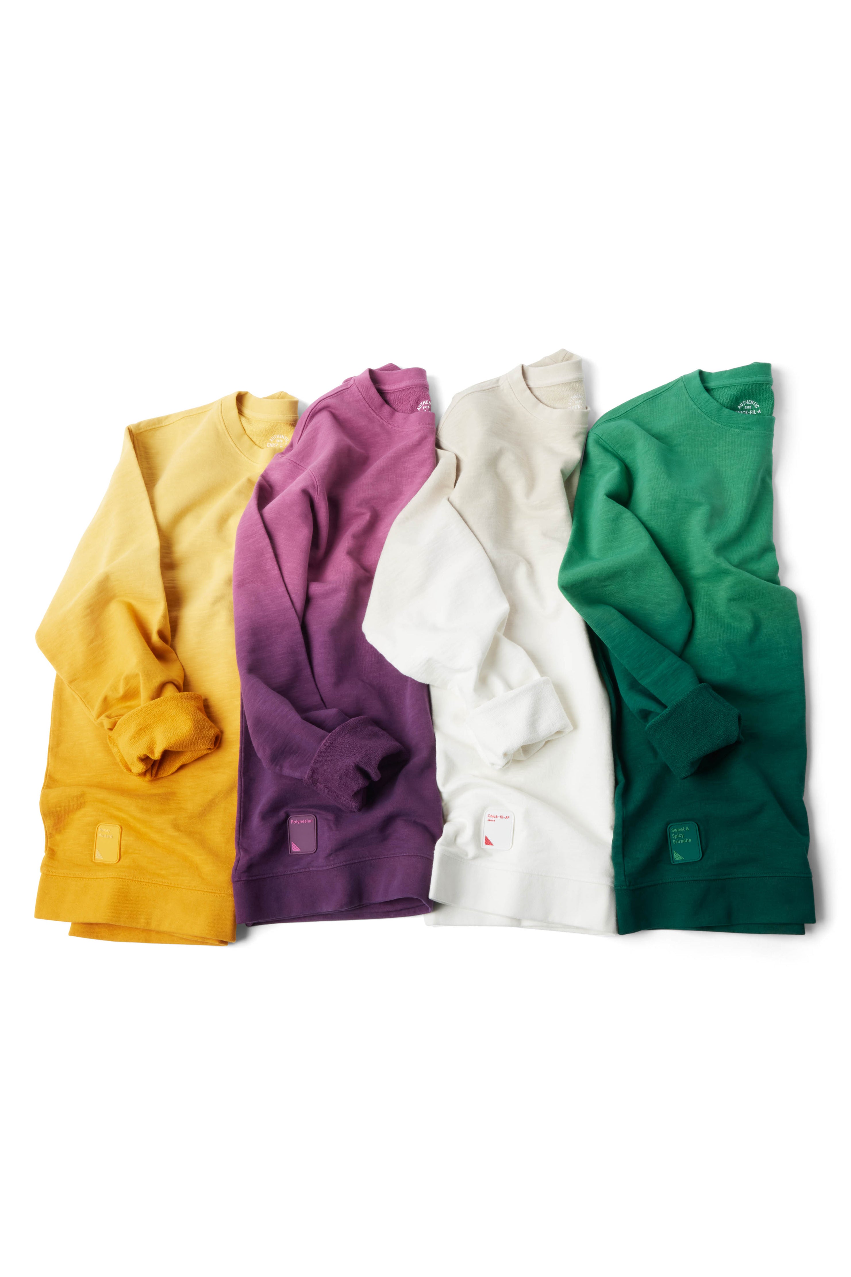 Yellow, purple, gray/white, and green Ombre Crewnecks laying in a row