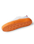 Side view of the bottom tread of single Dipped Kicks white shoes with orange soles