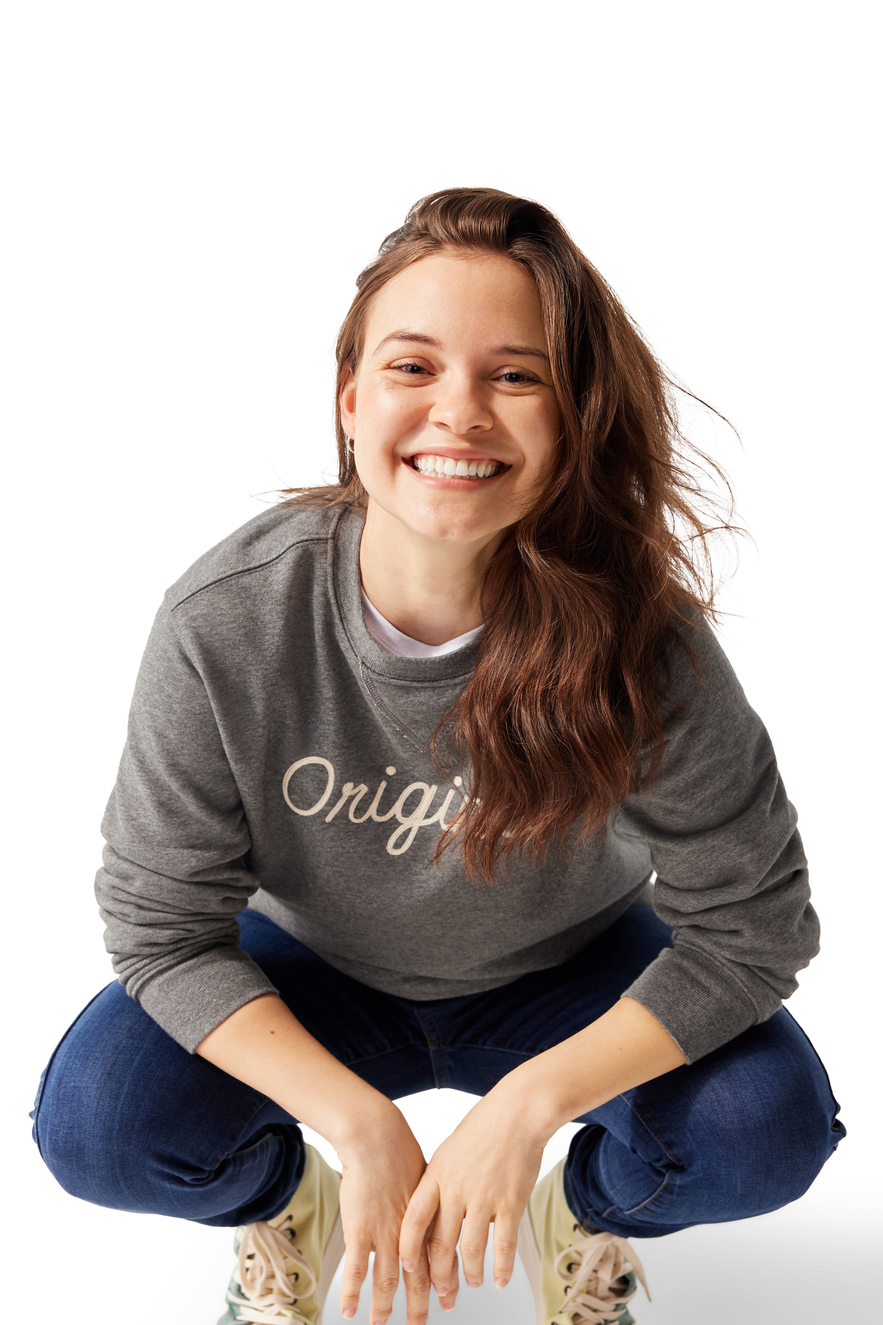 Woman wearing Original Crewneck, squatting down and smiling