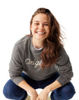 Woman wearing Original Crewneck, squatting down and smiling