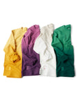 Yellow, purple, gray/white, and green Ombre Crewnecks laying in a row