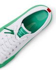 Top view of the drip patterned insole of the Dipped Kicks white shoes with green soles